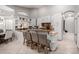 Kitchen with white cabinets, breakfast bar, tile backsplash, and lots of natural light at 7866 W Taro Ln, Glendale, AZ 85308