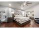 Bright main bedroom with a ceiling fan, walk-in closet and wood floors at 7866 W Taro Ln, Glendale, AZ 85308