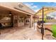 Covered outdoor kitchen with built-in grill and bar seating perfect for entertaining at 7866 W Taro Ln, Glendale, AZ 85308