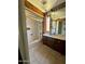 Well-lit bathroom with decorative wood accents and a shower-tub combination at 7921 W Pinchot Ave, Phoenix, AZ 85033