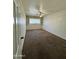 Cozy bedroom with built-in shelving, a ceiling fan and neutral carpeting at 7921 W Pinchot Ave, Phoenix, AZ 85033