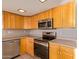 Well-equipped kitchen boasts stainless steel appliances and wooden cabinetry at 800 W 12Th St, Tempe, AZ 85281