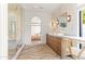 Modern bathroom featuring double vanities, natural light, and glass enclosed shower and herringbone floors at 8206 E Del Camino Dr, Scottsdale, AZ 85258