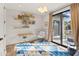 Stylized bedroom features floating bookshelves, chair swing, and a sliding glass door leading to the pool at 8206 E Del Camino Dr, Scottsdale, AZ 85258