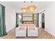 Bright bedroom featuring a four-poster bed, slider to backyard, and unique light fixtures at 8206 E Del Camino Dr, Scottsdale, AZ 85258