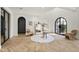 Bright and airy foyer boasting herringbone floors, arched doorways, and chic decor at 8206 E Del Camino Dr, Scottsdale, AZ 85258