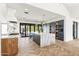 Modern kitchen features a large island, stainless steel appliances and light-colored herringbone floors at 8206 E Del Camino Dr, Scottsdale, AZ 85258