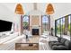 Bright living room with fireplace, high ceilings, large windows and modern finishes at 8206 E Del Camino Dr, Scottsdale, AZ 85258