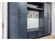 Mudroom with built-in storage, including cabinets, shelves, hooks, and bench, creating an organized entry space at 8206 E Del Camino Dr, Scottsdale, AZ 85258