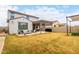 The spacious backyard features a covered patio and green grass at 8740 W San Miguel Ave, Glendale, AZ 85305