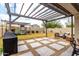 This backyard includes a patio, pavers, green grass, a pergola, and a playset at 8740 W San Miguel Ave, Glendale, AZ 85305