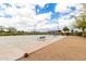 Outdoor basketball court with hoops, seating and lighting within the community at 8740 W San Miguel Ave, Glendale, AZ 85305