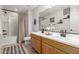 This bathroom features a double sink vanity, a large mirror, and a shower-tub combination at 8740 W San Miguel Ave, Glendale, AZ 85305