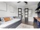 Comfortable bedroom featuring a daybed, built-in desk area, plush rug, and modern decor at 8740 W San Miguel Ave, Glendale, AZ 85305