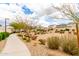 Landscaped common area featuring desert plants and a walking path in a quiet community setting at 8740 W San Miguel Ave, Glendale, AZ 85305