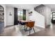 Well-lit dining area with modern decor, hardwood floors, a large window, and a contemporary table and chairs at 8740 W San Miguel Ave, Glendale, AZ 85305