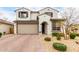 Charming two-story home featuring neutral stucco, two car garage, and low maintenance desert landscaping at 8740 W San Miguel Ave, Glendale, AZ 85305