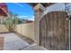 Rustic wood gate with a stone pillar accents this cozy backyard, offering privacy and outdoor charm at 8840 S 51St St # 2, Phoenix, AZ 85044