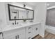 Bathroom featuring double sinks, black hardware and bright lighting at 8840 S 51St St # 2, Phoenix, AZ 85044