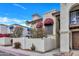 Exterior view showing manicured landscaping, red awnings, balcony, and walkway at 8840 S 51St St # 2, Phoenix, AZ 85044