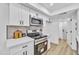 Charming kitchen featuring stainless steel appliances, white cabinetry, and a stylish tile backsplash at 8840 S 51St St # 2, Phoenix, AZ 85044