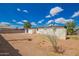 Spacious backyard featuring a white home exterior with a patio, and a lush sky backdrop at 9127 E Broadway Rd, Mesa, AZ 85208