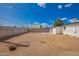 Expansive backyard featuring a white home exterior with a patio, enclosed by a block fence at 9127 E Broadway Rd, Mesa, AZ 85208