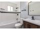 Bathroom featuring a sink, toilet, bathtub and shower with black and white tiles at 9127 E Broadway Rd, Mesa, AZ 85208