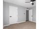 Bedroom featuring carpeted floor and two doors, one leading to another room at 9127 E Broadway Rd, Mesa, AZ 85208