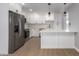 Modern kitchen with stainless appliances, white cabinets, and sleek breakfast bar at 9127 E Broadway Rd, Mesa, AZ 85208