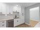 Bright kitchen with subway tile backsplash, stainless dishwasher, and new white cabinetry at 9127 E Broadway Rd, Mesa, AZ 85208