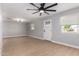 Bright living room with new ceiling fan, wood-look floors, and ample natural light at 9127 E Broadway Rd, Mesa, AZ 85208