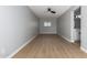 Living room with light blue brick walls, ceiling fan, and wood floor at 9127 E Broadway Rd, Mesa, AZ 85208