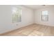 Well-lit bedroom featuring wood-look flooring and windows showcasing the surrounding neighborhood at 9643 N 81St Dr, Peoria, AZ 85345