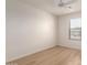 Light-filled bedroom with wood-look flooring, offering a cozy atmosphere with one window at 9643 N 81St Dr, Peoria, AZ 85345