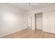 Bright bedroom featuring wood-look flooring, a doorway and a spacious closet enhancing storage options at 9643 N 81St Dr, Peoria, AZ 85345