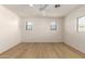 Bright bedroom featuring wood-look flooring, a ceiling fan, and scenic outdoor views from the windows at 9643 N 81St Dr, Peoria, AZ 85345