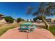 Community park with a blue picnic table, mature trees, and historical plaques at 9643 N 81St Dr, Peoria, AZ 85345