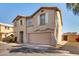 Two-story home exterior featuring shutters, desert landscaping, and attached garage at 9643 N 81St Dr, Peoria, AZ 85345