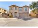 Two-story home exterior featuring shutters, desert landscaping, and an attached garage at 9643 N 81St Dr, Peoria, AZ 85345