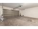 Spacious garage with a multi-section door and concrete floor at 9643 N 81St Dr, Peoria, AZ 85345