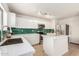 Open plan kitchen with white cabinets, stainless steel appliances, and a center island at 9643 N 81St Dr, Peoria, AZ 85345