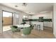 Bright kitchen featuring white cabinets, stainless steel appliances and a sliding glass door at 9643 N 81St Dr, Peoria, AZ 85345