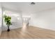 Bright living room with wood-look floors and access to the stairway and backyard sliding door at 9643 N 81St Dr, Peoria, AZ 85345