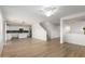 Bright open-plan living room featuring hardwood floors, stairs, and a modern kitchen at 9643 N 81St Dr, Peoria, AZ 85345