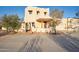 Exterior facade of the home featuring desert landscaping, stucco exterior and arched entryway at 10303 E Hummingbird Ln, Gold Canyon, AZ 85118