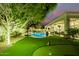 Expansive backyard features a pool, putting green, and lush artificial grass for year-round enjoyment at 10534 N 133Rd St, Scottsdale, AZ 85259