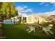 Scenic backyard featuring a putting green, a seating area, and a sparkling pool for recreation at 10534 N 133Rd St, Scottsdale, AZ 85259