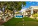 Luxurious backyard oasis with a pool, putting green, and a covered patio for outdoor entertaining at 10534 N 133Rd St, Scottsdale, AZ 85259