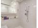 Bright bathroom featuring a shower with tile surround and a built-in shelf for toiletries at 10534 N 133Rd St, Scottsdale, AZ 85259
